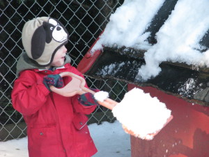 B commences removing snow from the playhouse roof.