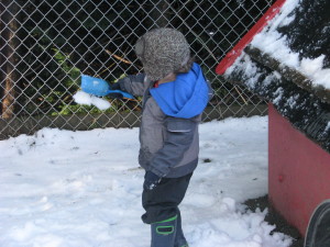 H continues to take snow off of the roof and drop it onto the ground.